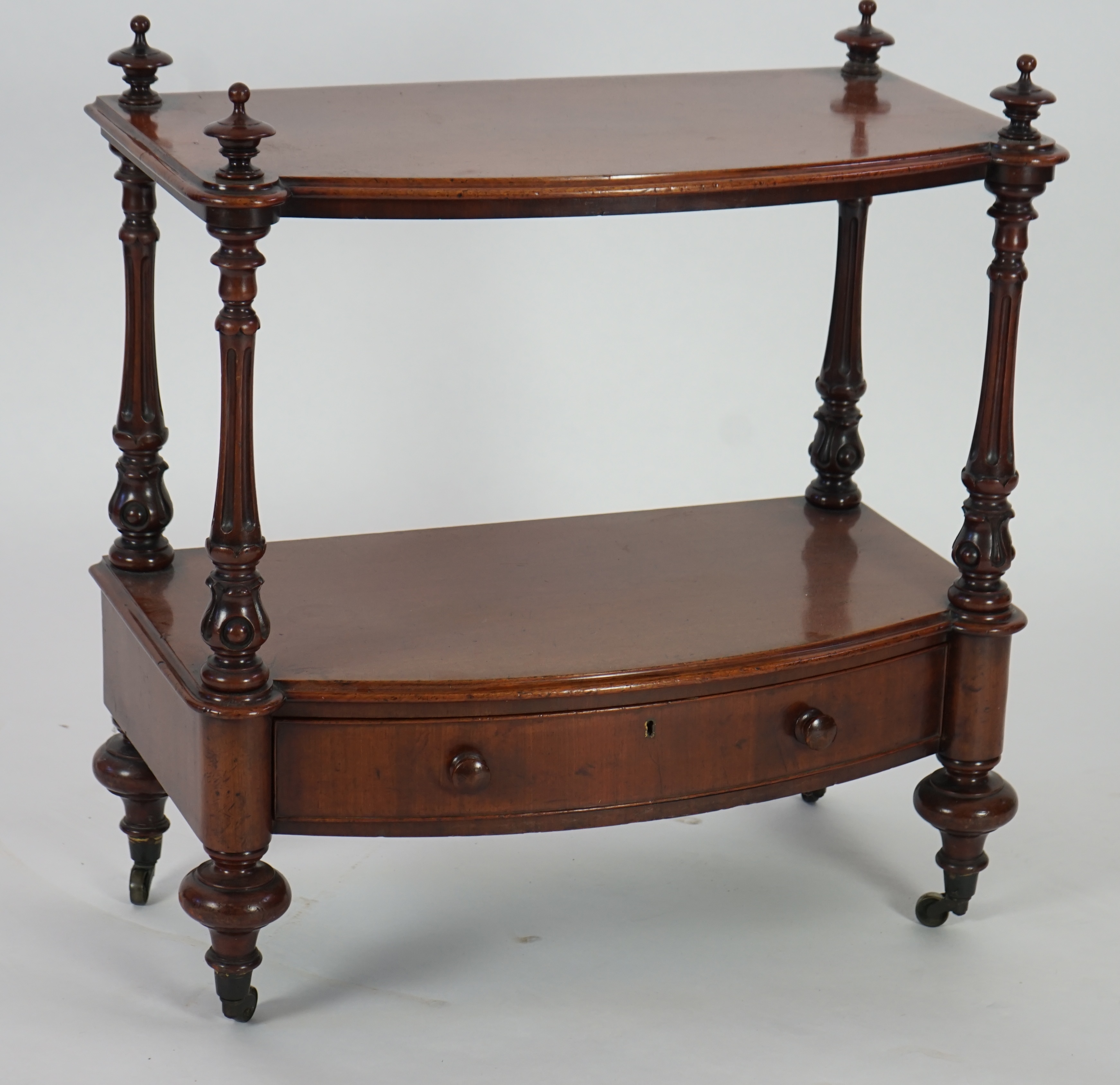 A Victorian mahogany bow fronted two tier whatnot, with fitted drawer, width 66cm, height 73cm. Condition - good